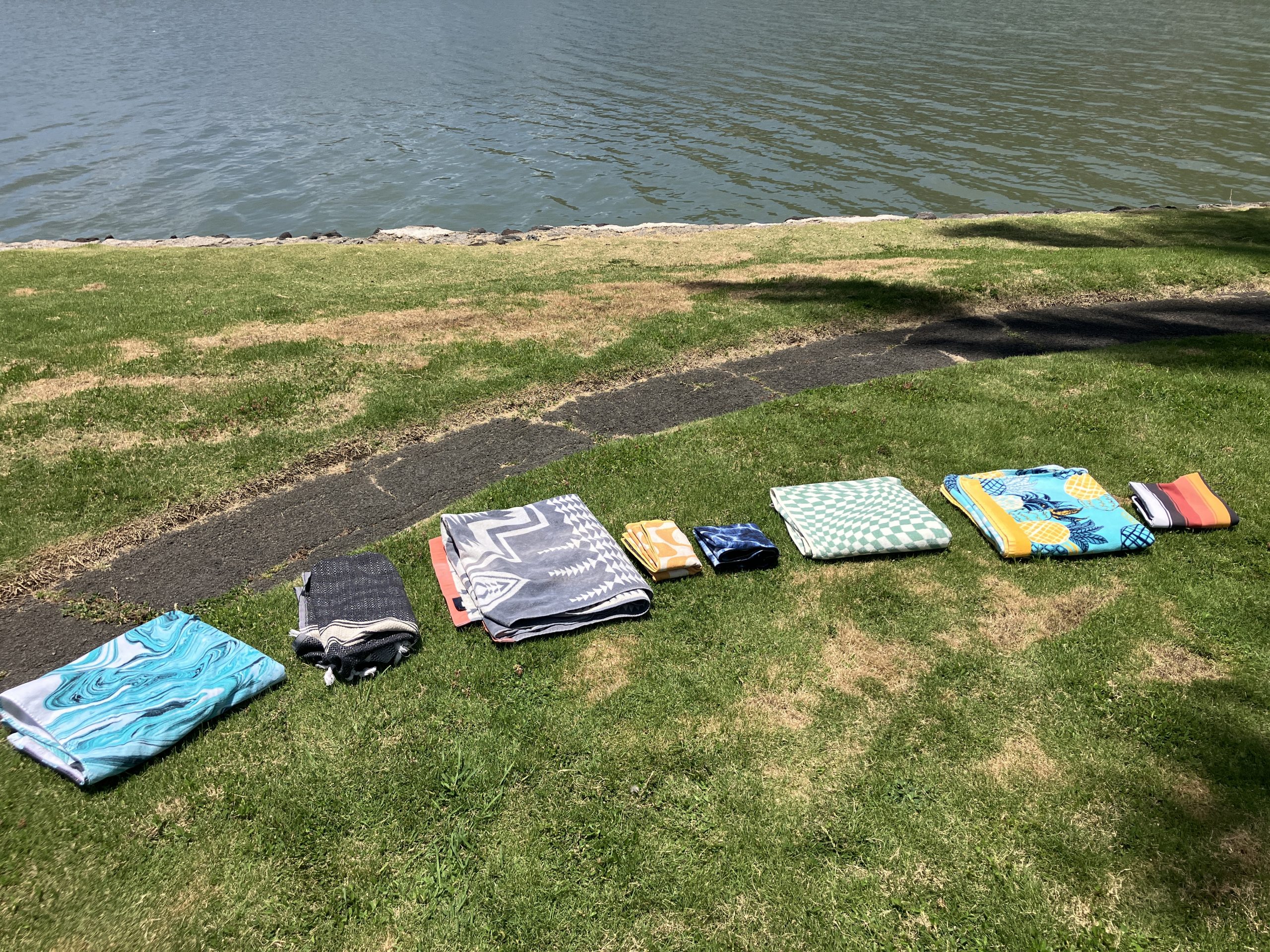 a bunch of beach towels folded up 