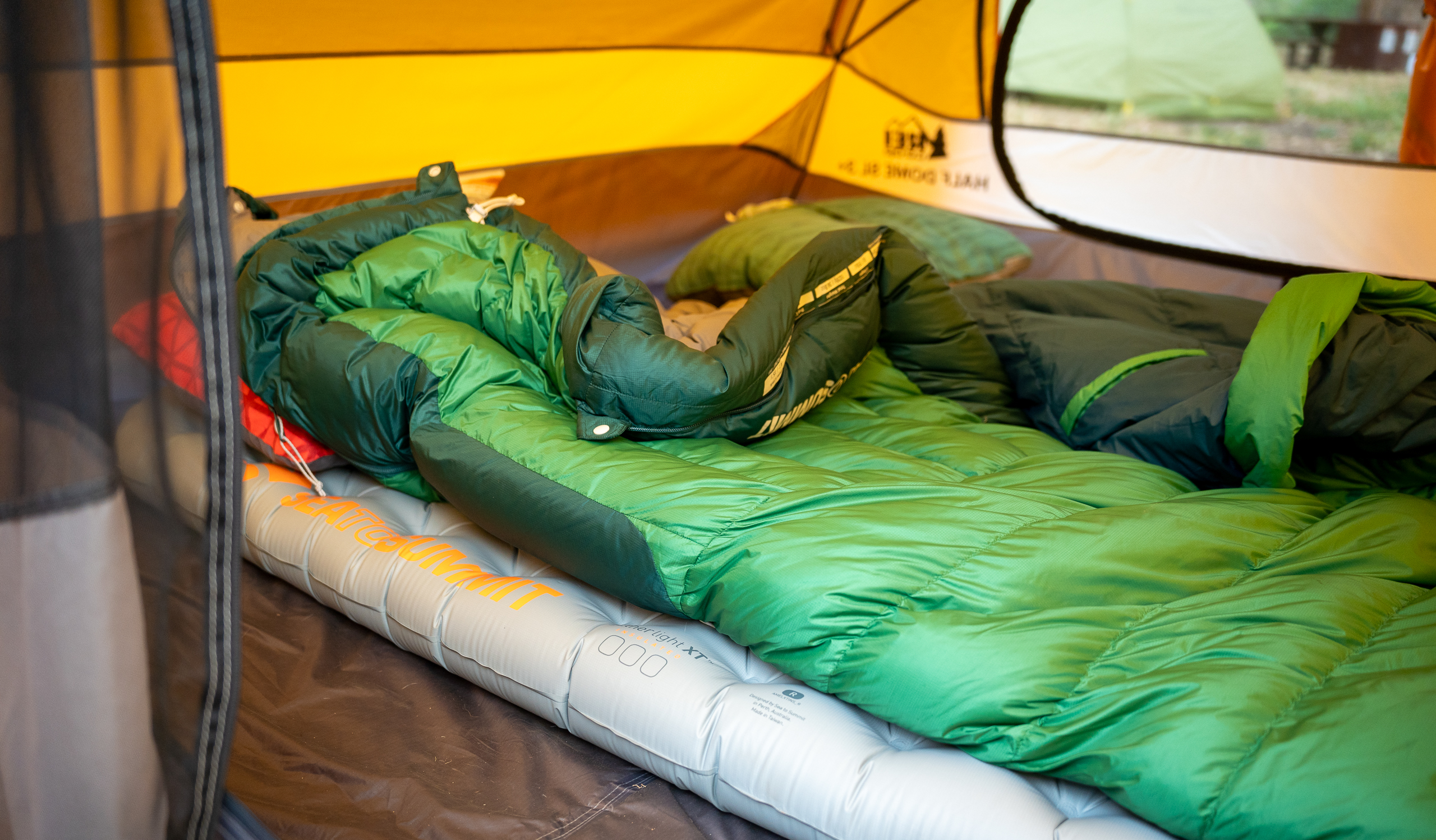 a backpacking sleeping pad with a sleeping bag on top