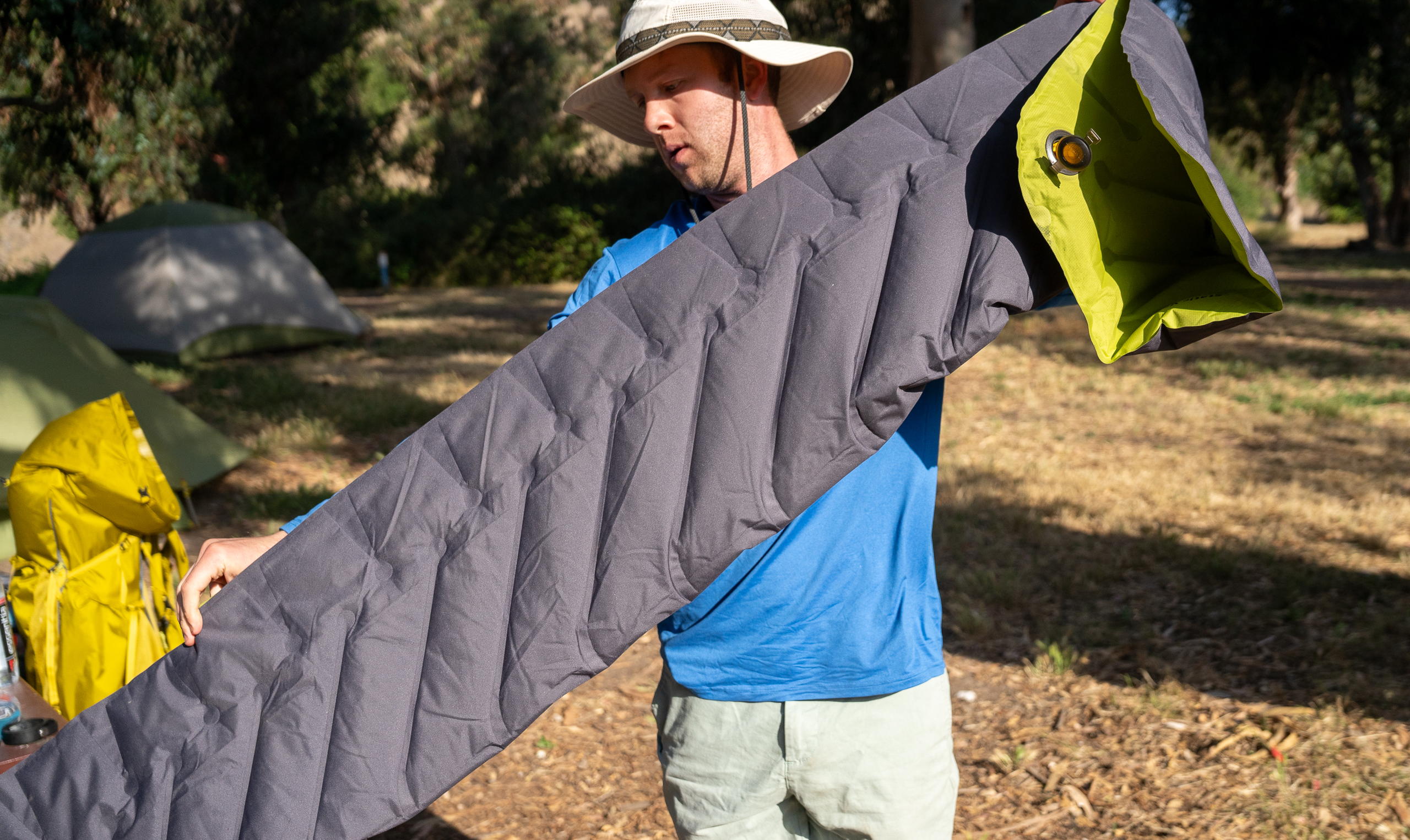 a man folding a backpacking sleeping pad