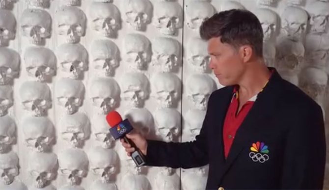 Colin Jost interviewing wall of skulls