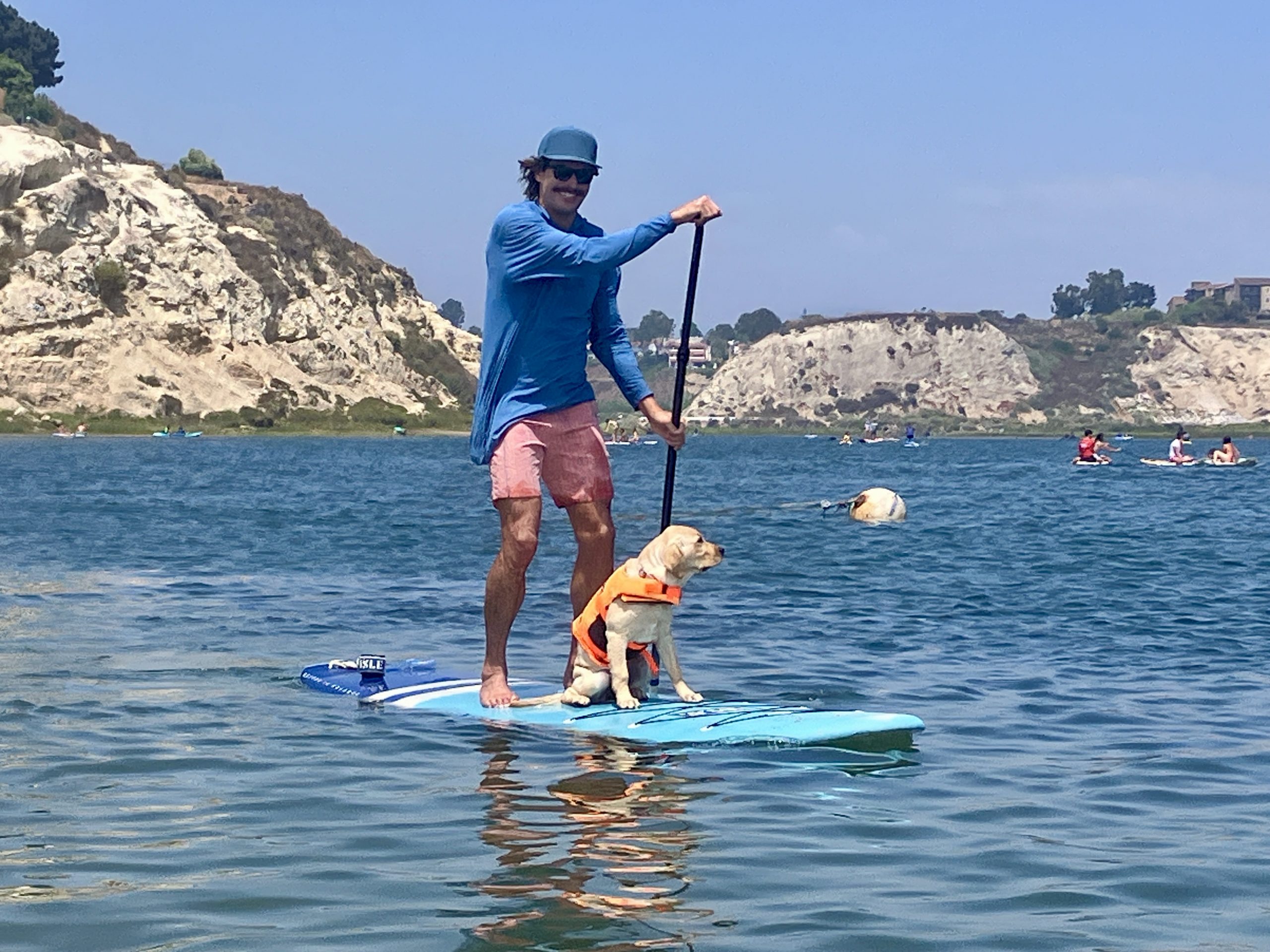 a man and a dog on a Cruiser 2 paddle board