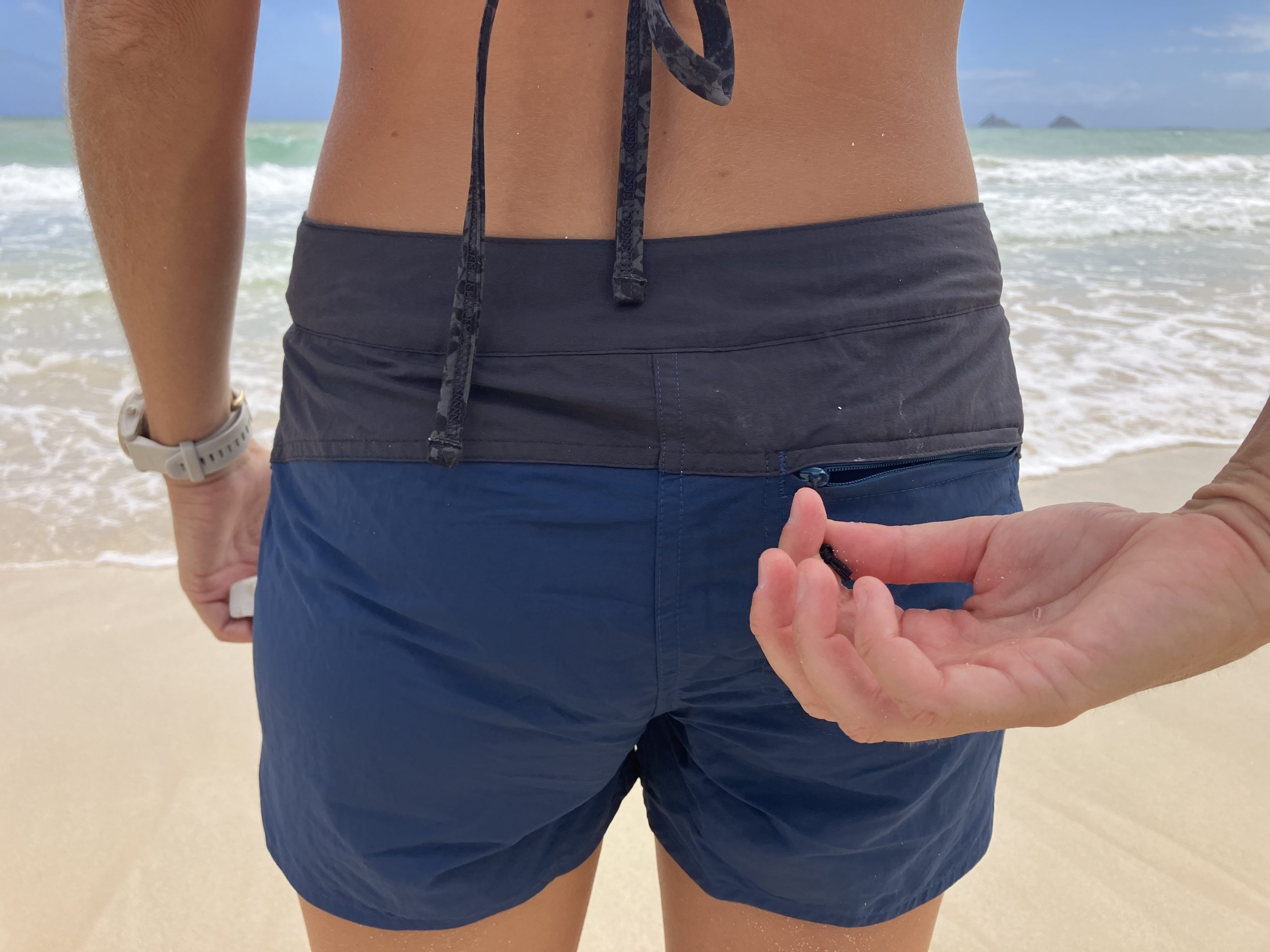 a zippered pocket on a pair of board shorts