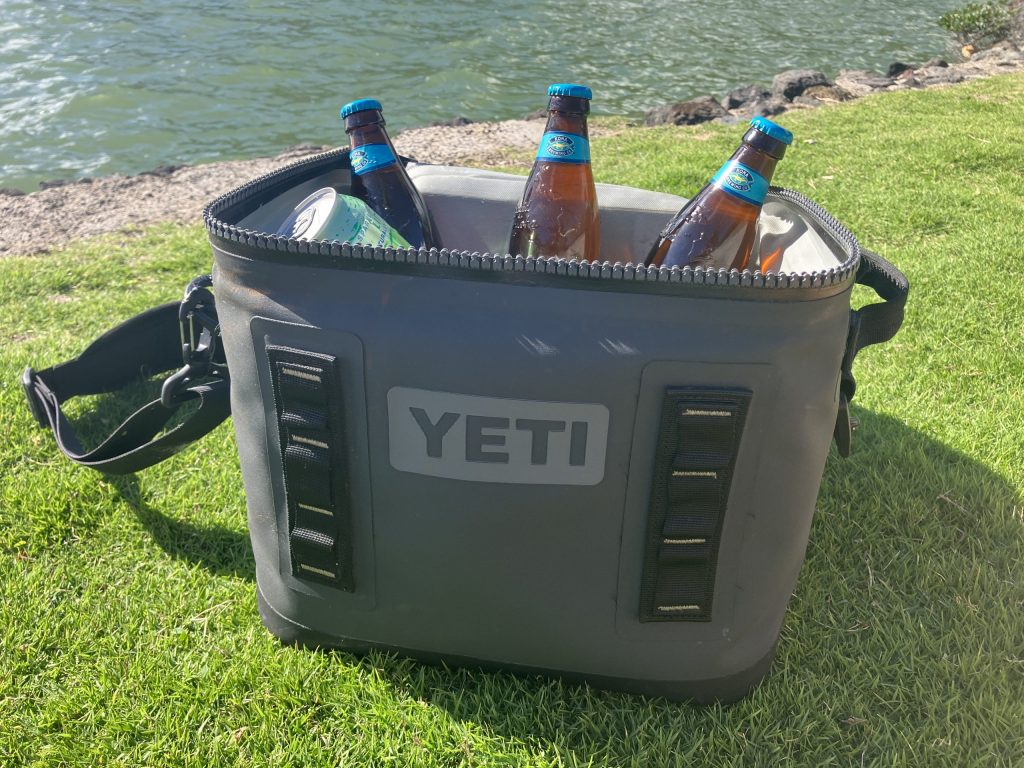 cooler with drinks next to water