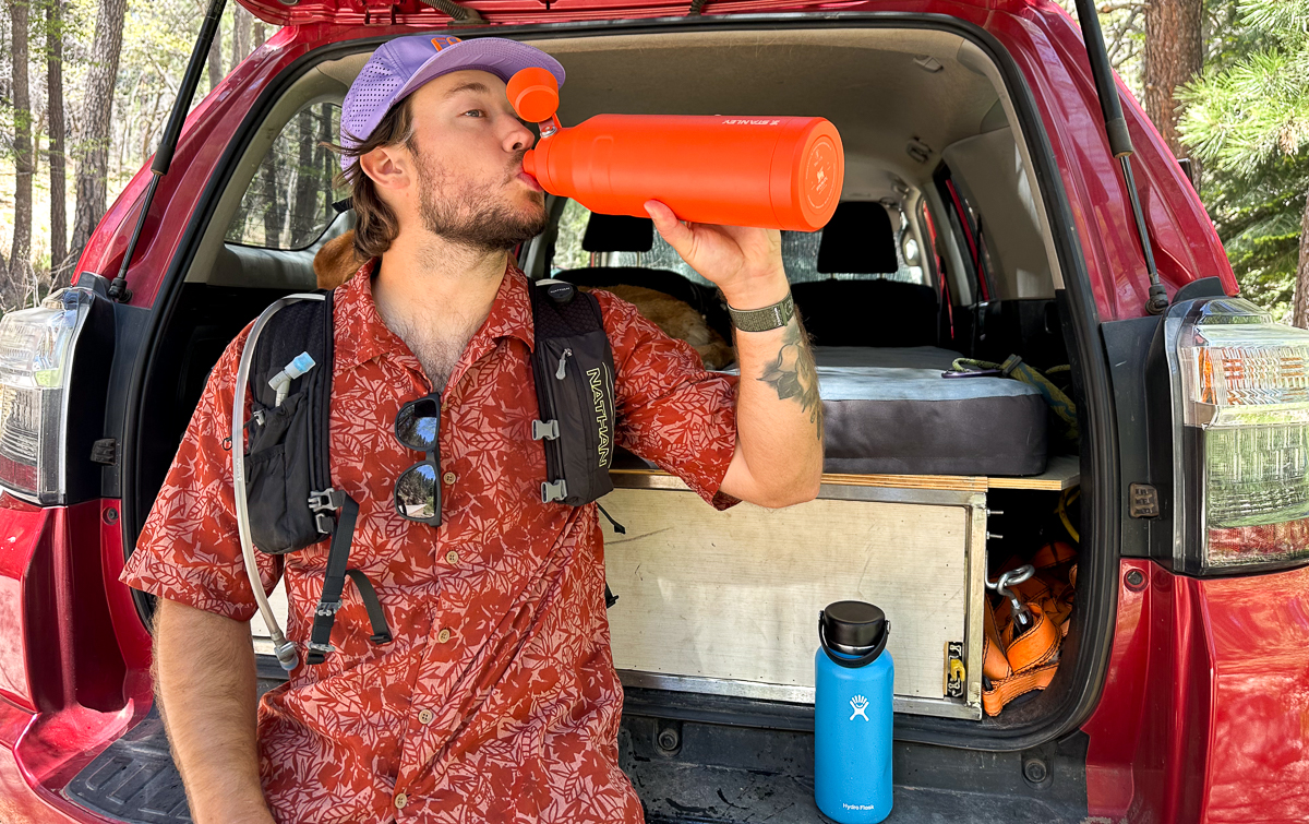 man drinking from water bottle