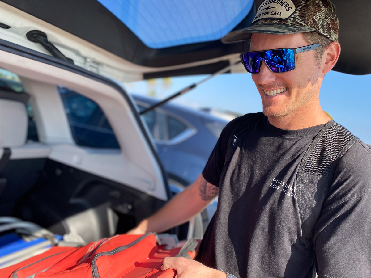 man wearing sunglasses near car