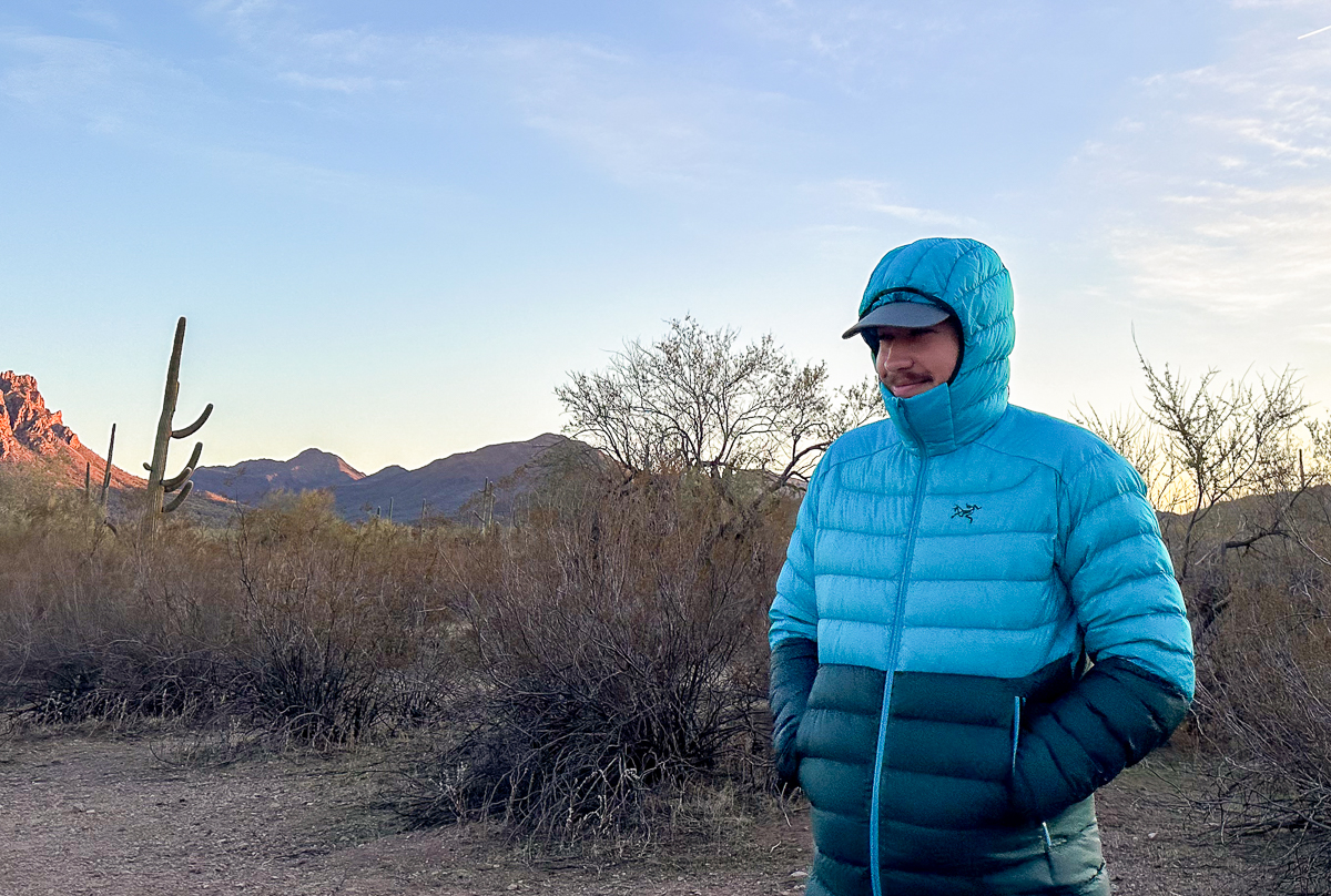 man wearing puffer jacket in desert