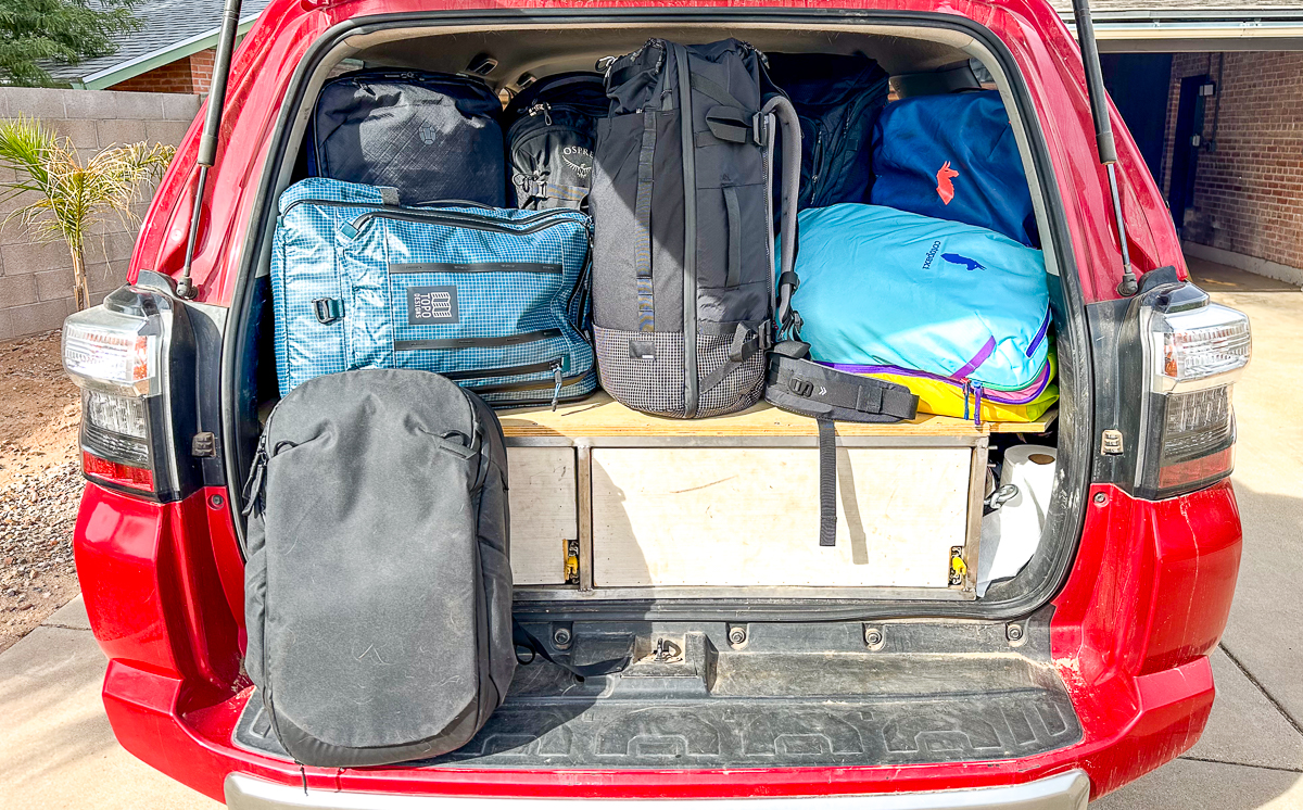 trunk full of travel backpacks