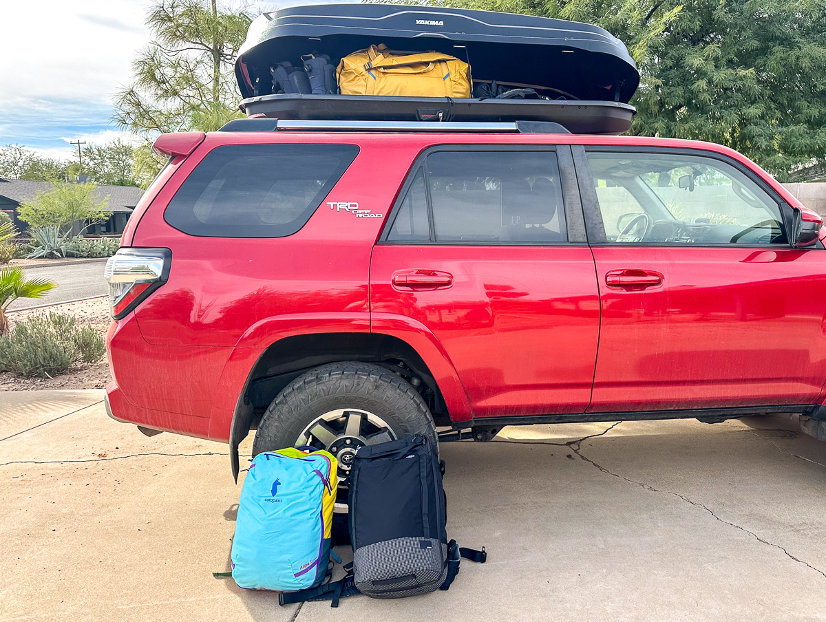 travel backpacks near a car