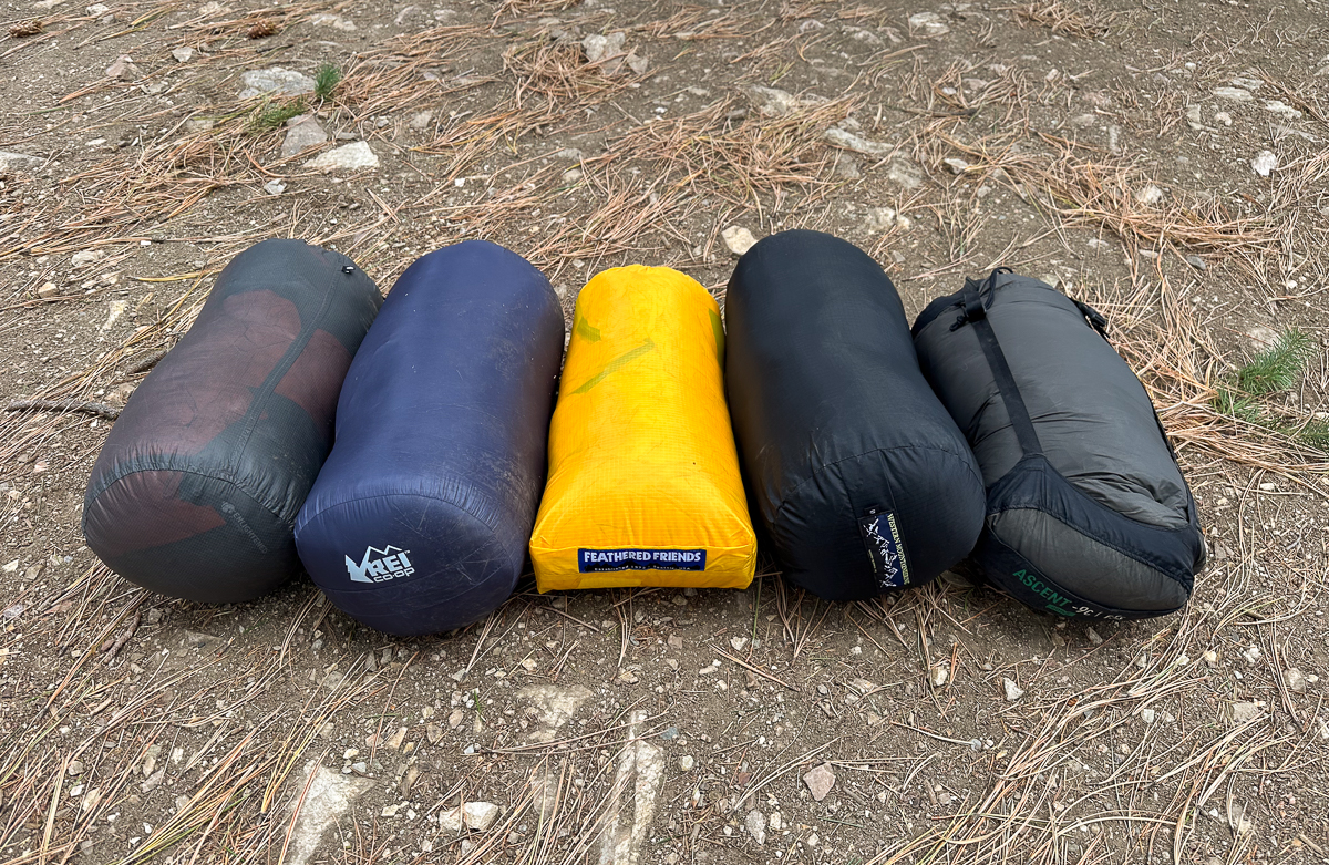 Packed backpacking sleeping bags to show comparison in size