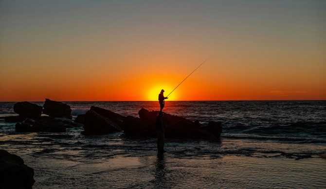 fisherman on rock