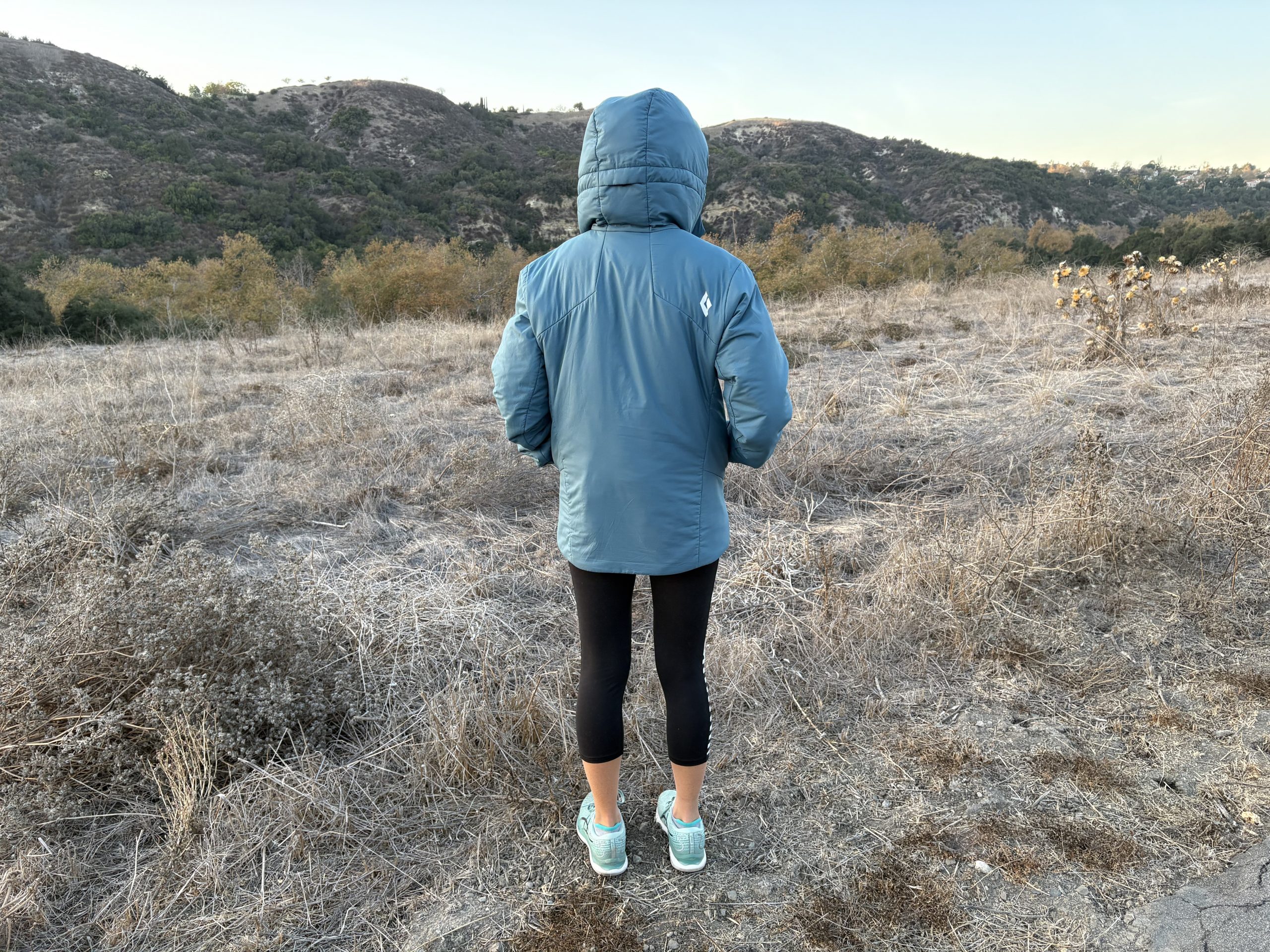 the backside of a puffer jacket on a woman