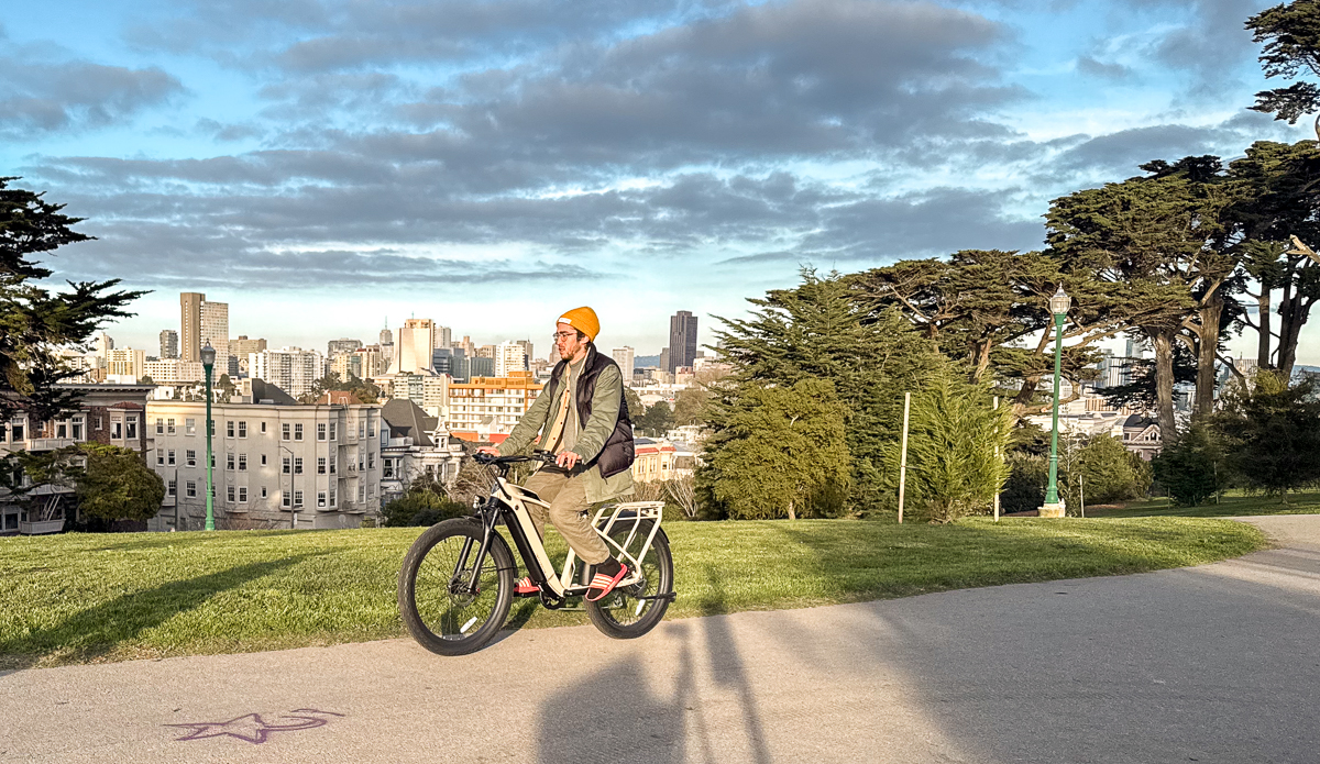 man riding ebike through park