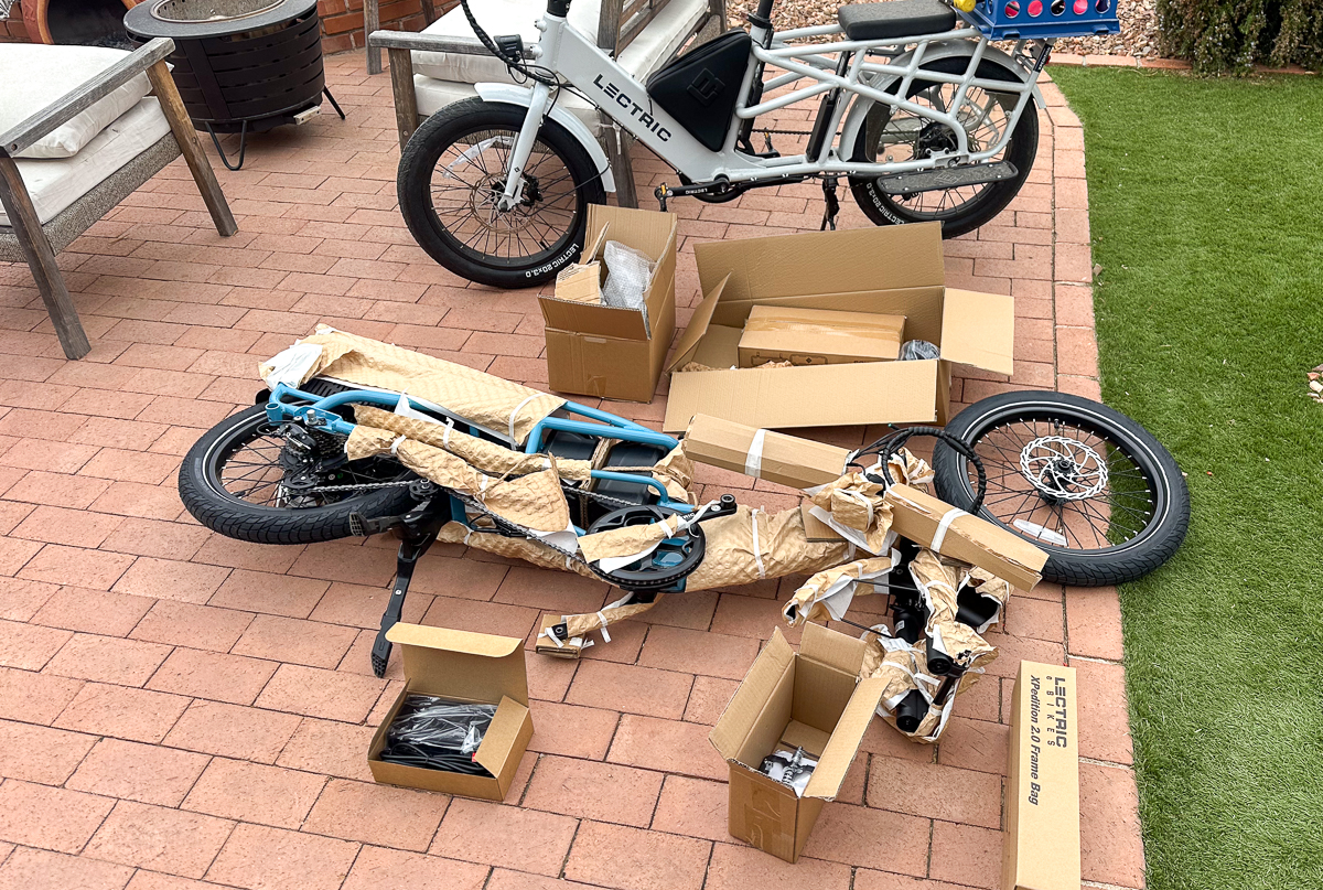 unassembled ebike next to assembled ebike